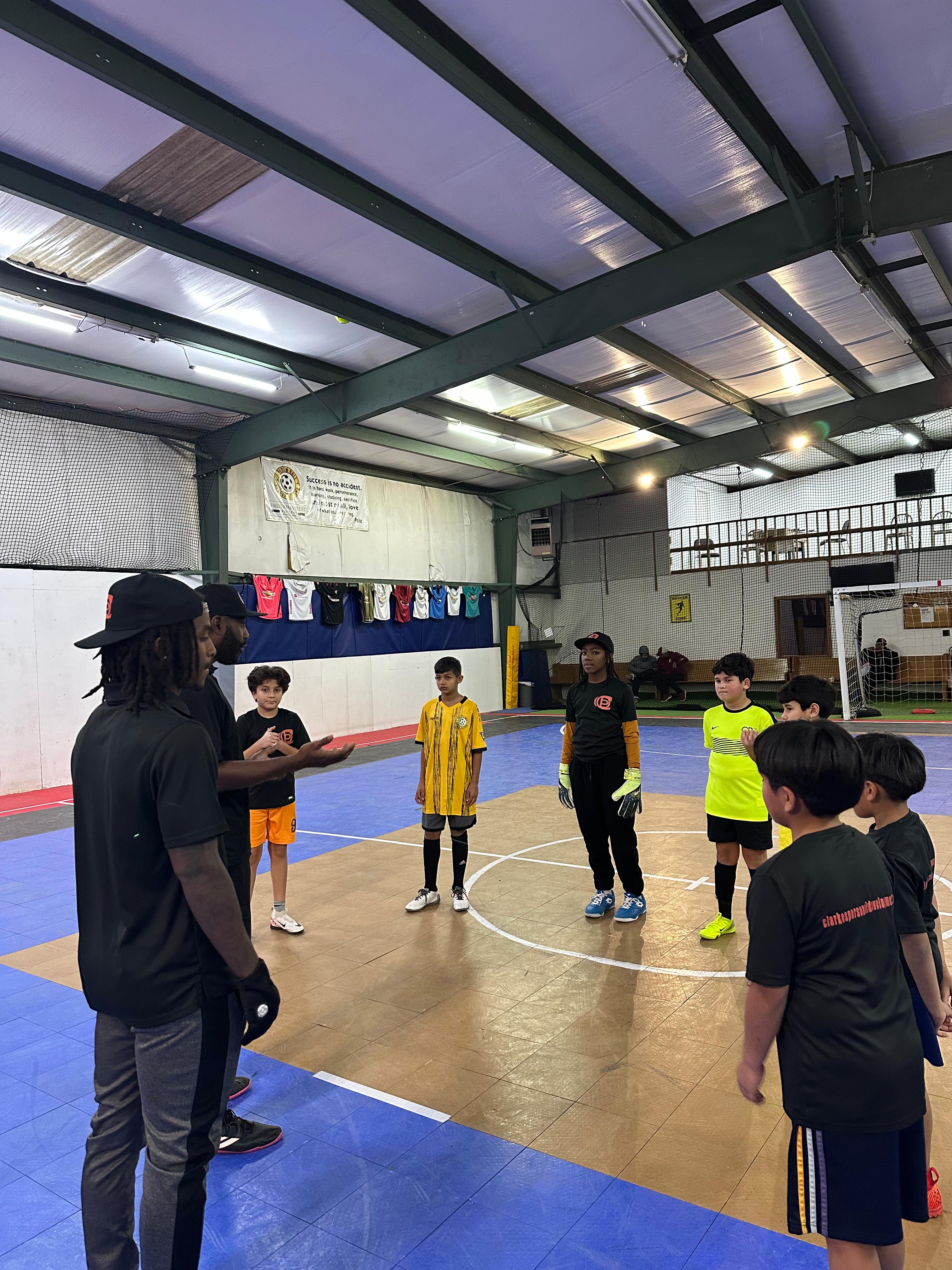 Coach giving a team talk to young players